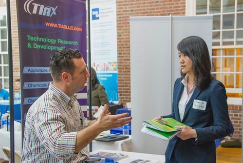 a student speaks with a company rep about job opportunities