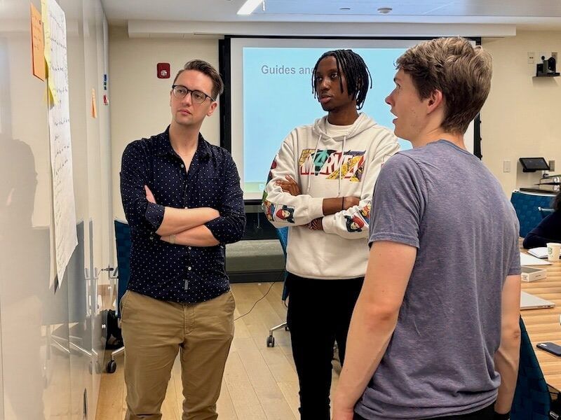 DEE tutors discuss teaching methods in a training session in Dartmouth's Engineering and Computer Science Center.