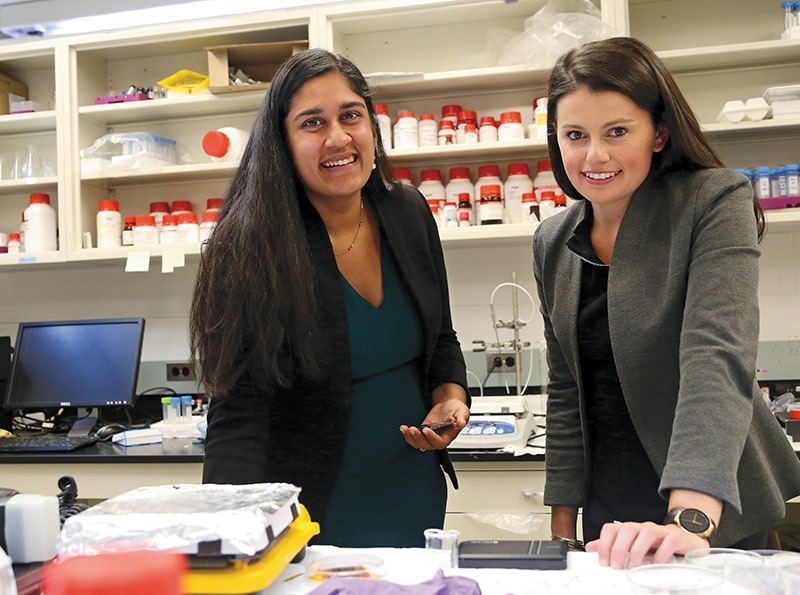 Two female I-Corps Grant awardees work on a research project together in a lab.
